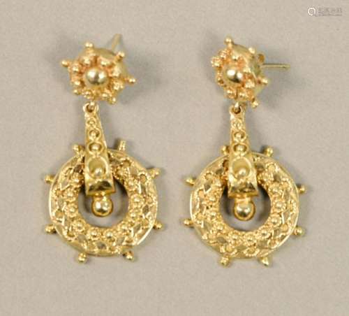 Pair of 14K gold pierced earrings with ships wheel