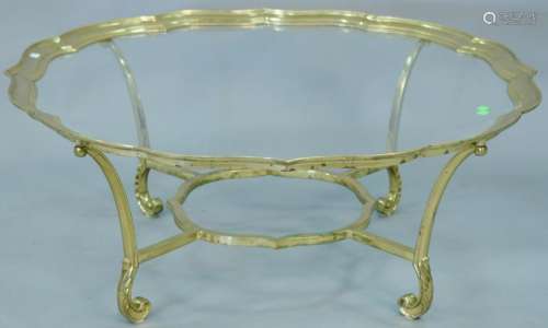 Brass trimmed glass coffee table. ht. 16 1/2 in., dia.