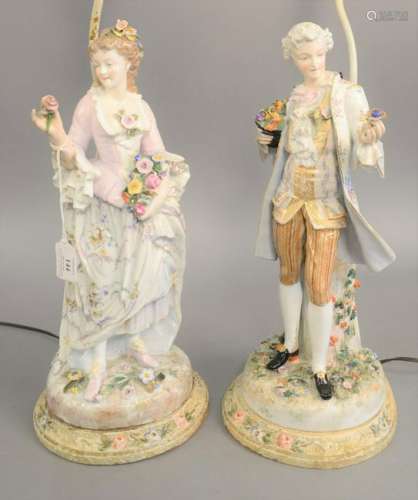 Pair of porcelain figures, man and woman each holding a