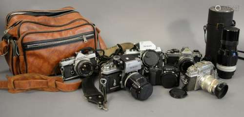 Vintage camera lot including three Nikons and lense.