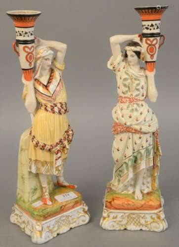 Pair of porcelain figural candlesticks, Eastern man and