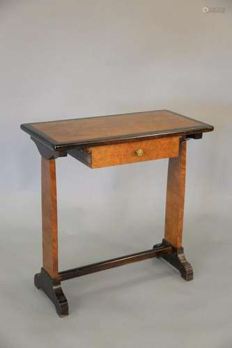 An English yew wood writing table and oval mirror with