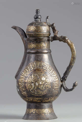 An Islamic silver inlaid copper ewer