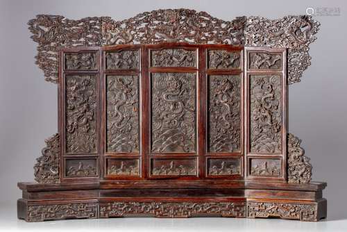 A Chinese hardwood carved ‘dragons’ table screen