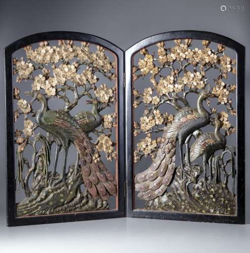 Two Chinese panels of carved peacocks