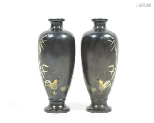 Meiji era A mirrored pair of inlaid bronze vases