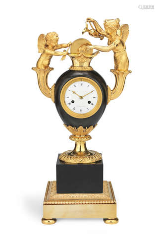 Le Sieur a Paris  A fine early 19th century French Empire gilt and patinated bronze figural clock depicting Cupid sharpening his arrow of love