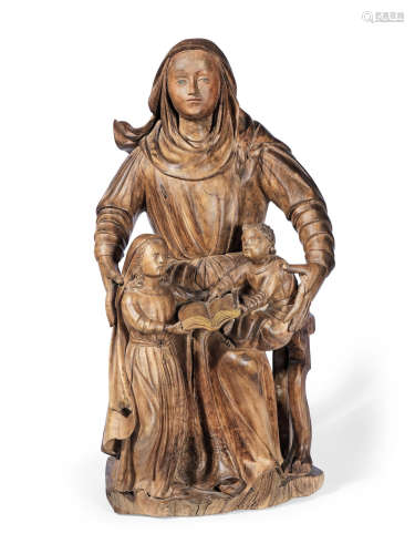 A Portuguese late 17th century carved olive wood group of The Virgin Mary holding the Christ Child and St Anne