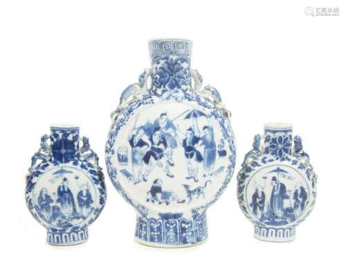 Circa 1900 A pair of blue and white moonflasks, and another