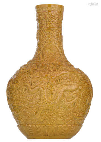 A Chinese mustard-yellow glazed bottle vase, relief decorated with the five-clawed dragon amidst clouds, the rims with flower petals, with a Qianlong mark, H 54,5 cm