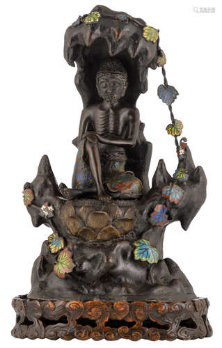 An Oriental champlevé enamel bronze figure, depicting a Lohan in a cave, on a matching wooden stand, H 42 (without base) - 48 cm (with base)