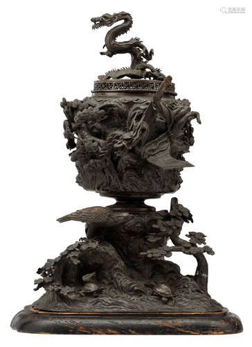 A Chinese bronze three-piece incense burner, decorated with trees, turtles, birds and a dragon, the cover dragon decorated, on a matching wooden base, H 54 (without base) - 57,5 (with base) - W 30 - D 31 cm