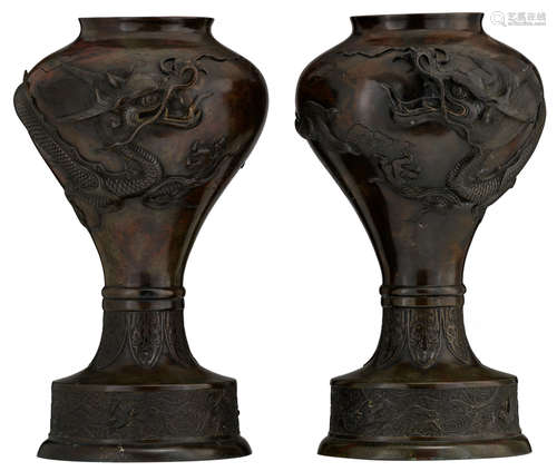 A pair of Oriental bronze vases, relief decorated with a dragon, the foot rim with petals, H 49,5 - 50 cm