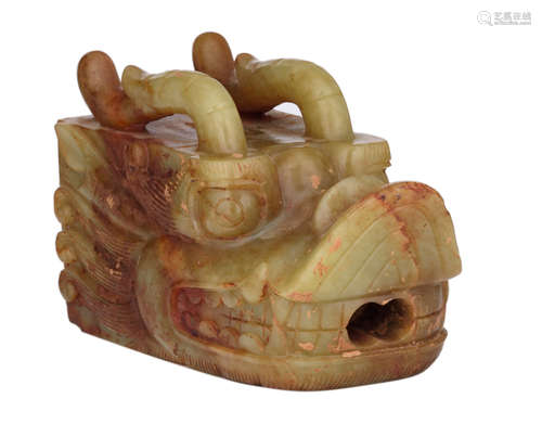 A Chinese russet jade pastiche, depicting a gargoyle, shaped as a dragon's head, 20thC, H 11,5 - W 8,5 - D 20,5 cm