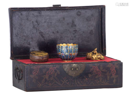 A Chinese black and painted lacquered box, containing three literate's ustensils, being a gilt bronze scroll weight, shaped as a mythical animal with a figure on his back, a cloisonné brush washer, gilt to the inside, and a bronze and gilt bronze seal paste box, 19thC, H 2,5 - 6 - ø 7 - 8 cm / the box H 13 - W 37,5 - D 20,5 cm