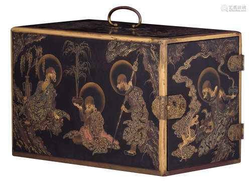 A relief and gold lacquered Japanese ladies vanity/jewellery cabinet, decorated with figures out of the Japanese pandemonium, the hinges and locks in engraved and patinated brass, Meiji period, H 27 - W 42 - D 25 cm