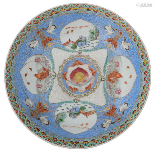 A Chinese famille rose charger, decorated with prosperity symbols like cranes and bats, the central roundel with a peach, finely enamelled in rose, encircled by bats in iron red and ruyi lappets, the surrounding peach-shaped roundels decorated with fish and kylins, with a Yongzheng mark, 19thC, H 7,5 - ø 40,5 cm