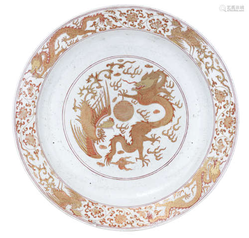 A Chinese iron red and gilt charger, decorated with phoenix and dragons, the reverse with bats and Shou signs, marked Guangxu, ø 39 cm