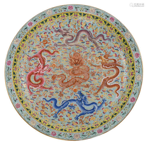 A Chinese turquoise ground famille rose charger, decorated with the five-clawed dragons, chasing the flaming pearl amidst clouds, enclosed by ruyi lappets, the outer rim with blossoming chrysanthemum scrolls, with a Qianlong and another mark, H 6,5 - ø 60 cm