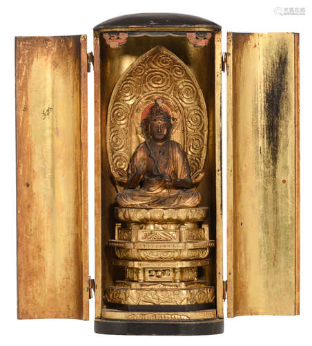 A Japanese Buddhist Zushi (portable shrine) with black lacquered wood exterior and brass mounts; in the gilt interior a seated Buddha on his throne and in the back a halo, Meiji-period, H in-all 33,5 cm.; with a certificate of M. Chr. Varosi - Bxl.