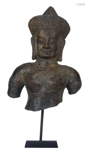 A bronze bust of a goddess, Southeast Asia, mounted by an iron rod on a wooden base, H 41,5 cm