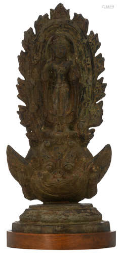 A probably Balinese cast brass Buddha, standing on Bhoma, the son of the earth, and surrounded by a halo, on a mahogany base, H 56,5 cm