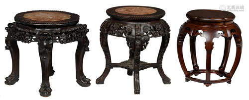 Two Chinese sculpted hardwood bases with a marble top, H 49 cm; added: a Chinese rosewood garden seat with a burl wood top, H 46 cm