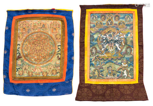 Two Tibetan or Nepalese 19th / 20thC thangka's, textile on paper, with their textile mounts and front curtain, 40,5 x 62,5 - with mount 67 x 91 cm / 41,5 x 55 - with mount 64 x 83 cm