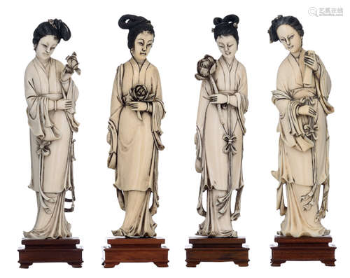 Four Chinese ivory beauties with engraved and black stained decoration, on an exotic wooden base, late Qing / first half of the 20thC, H 20,5 - 20,7 (without base) - 23,2 - 23,5 (with base), total weight all-in 1261 gAdded expertise report according to CITES legislation. For European Community use only.