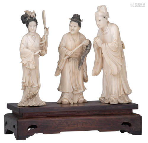 A Chinese ivory group, depicting the first meeting of a wedding couple, accompanied by the woman matchmaker, late Qing, on a wooden base, H 21 - 28,5 cm (with base) ,total weight 2616 g (with base)Added expertise report according to CITES legislation. For European Community use only.