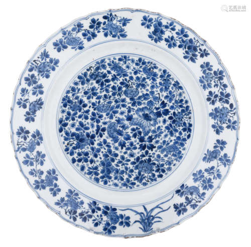 A Chinese blue and white floral decorated charger with a scalloped rim, with a Chengua mark, 18thC, H 5 - ø 36,5 cm