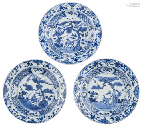 Three Chinese Kangxi blue and white deep plates, decorated with a pair of deer, galloping under a pine tree, 18thC, ø 21,5 - 22 cm