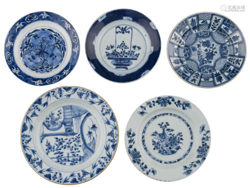 A Chinese Kangxi blue and white plate with pomegranates, with a Kangxi symbol mark, 18thC; added: four variously decorated plates, one plate with a flower basket, some plates with a still life, ø 21,5 - 27 cm
