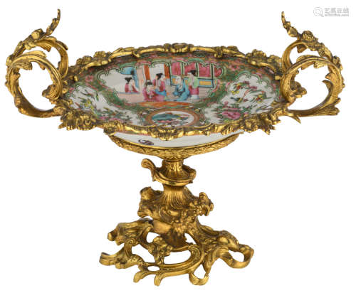A Chinese Canton famille rose plate, the roundels with court scenes and flower branches, with a rococo gilt bronze mount, H 29 - ø 36 cm  