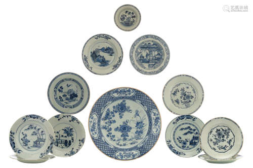 A Chinese Kangxi blue and white charger with flowers and auspicious symbols and a ditto dish with a lotus pond; added: nine blue and white variously decorated dishes with flowers, still lifes, a village landscape and figures on a terrace, some 18thC, ø 16 - 39 cm