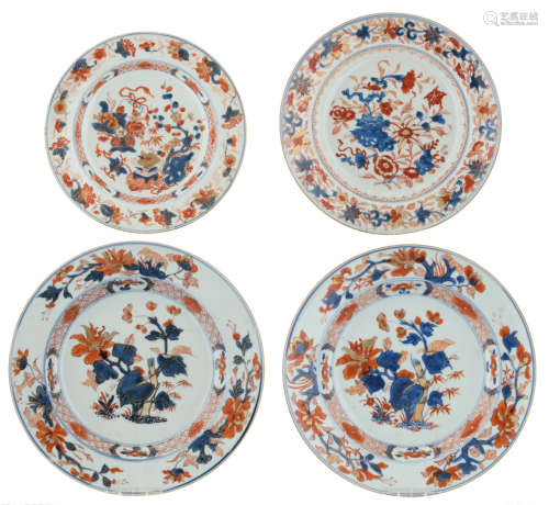 Two Chinese Imari plates, decorated with begonia flowers; added: two ditto plates, decorated with flower bundles, lotus roots, antiquities and the scholar's rock, 18thC, ø 23 - 26 cm