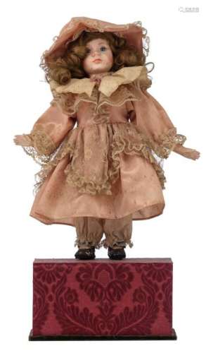 A late 19thC French mechanical musical dancing doll, with an original wig and lace decorated dress, H 40 cm (the doll) - 51 cm (the whole)