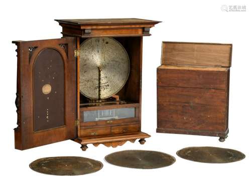 A Renaissance revival walnut hanging Polyphon-type music-box, the door with a chamfered edge mirror, added: a matching box containing twelve extra discs, late 19th - early 20thC, H 111 - W 79 - D 47 cm