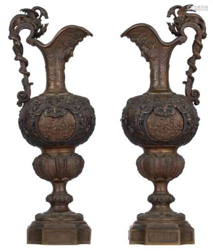 A pair of bronze Renaissance Revival relief decorated ewers, the handles decorated on top with a griffon fighting a snake, the roundels depicting a mythological Mars and Venus scene, H 75,5 cm