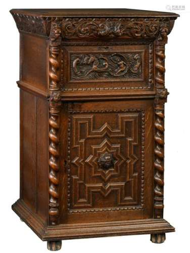 A typical oak Bruges so-called ‘bahut’ (cupboard) richly carved on top with a mythological scene, 17thC, H 127 - W 77 - D 60 cm