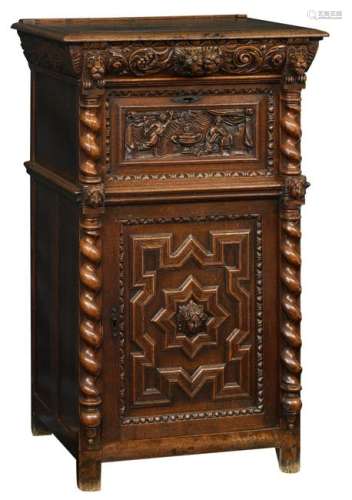 A typical oak Bruges so-called ‘bahut’ (cupboard) richly carved on top with a religious scene of the annunciation, 17th/18thC, H 127 - W 78 - D 60 cm