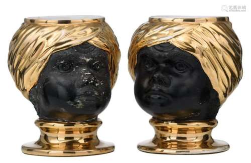 A pair of gilt glazed and cold painted creamware blackamoor jardinieres, in the style of Piero Fornasetti's 'Testa di Moro', H 29 cm
