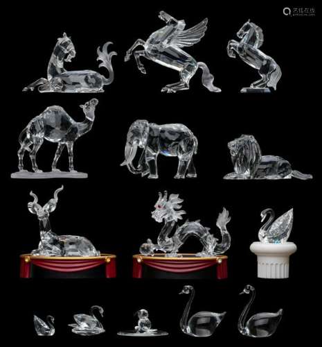 A collection of Swarovski crystal figurines, containing several annual editions, such as the Chinese Dragon, the Unicorn, Pegasus, and others; added; a few smaller Swarovski crystal figurines, (14 pieces in total), H 3 - 12,5 cm