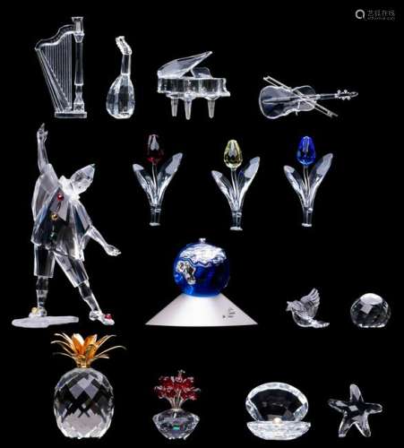 A collection of Swarovski crystal figurines, containing annual editions, such as the Masquerade Pierrot and the crystal planet; added: a few smaller Swarovski crystal figurines, (14 pieces in total), H 2 - 20,5 cm