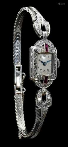 An 18ct white gold ladies wristwatch set with brilliant-cut diamonds and pavé cut rubies, marked on the movement 'Dreffa Swiss Watch', interwar period, weight (movement excl. - glass incl.) 20,2 g - total length open17 cm - ø 5.2 cm