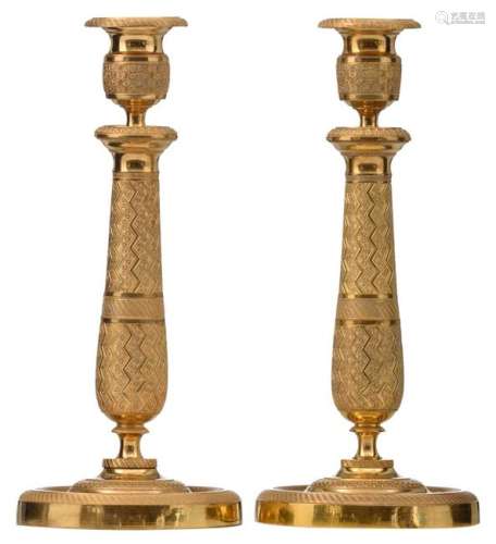 A pair of French Restauration period gilt bronze candlesticks,1815 - 1830, H 28,5 - 29 cm