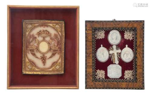 Four carved so-called 'Jerusalem' mother of pearl pendants, one crucifix and one escutcheon with the coat of arms of the baroness Marie van Hoobbrouck of Heule, the whole presented in a with silver (?) and red velvet decorated case, 29 x 34 cm (the case); added: a richly decorated paperolle reliquary devotional work, with a wax medallion in the centre, depicting the 'Mystic Lamb', 19thC, 35 x 42 cm