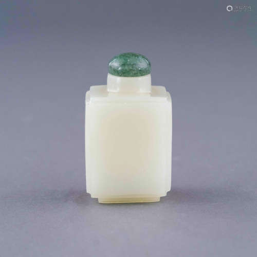 A CARVED WHITE JADE SNUFF BOTTLE