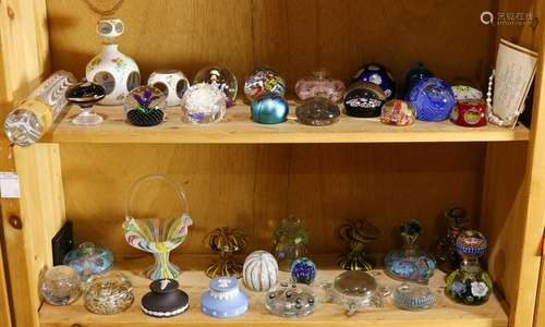 Two shelves of mostly paperweights by various makers