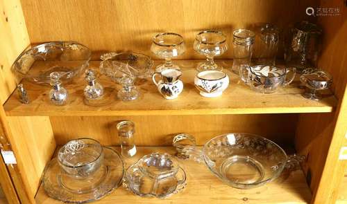 Two shelves of silver overlaid glassware